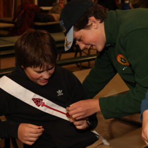 Order of the Arrow scouts check out the sash